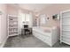 Cozy bedroom with light pink walls, a daybed, and window with shutter-style blinds at 11582 Jimenez St, Parker, CO 80134