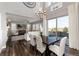 Open concept dining room with chandelier, large windows and an open view of the adjacent Gathering room at 11582 Jimenez St, Parker, CO 80134