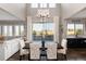 Dining room with high ceilings and large windows showing the backyard and a glimpse of the Gathering room at 11582 Jimenez St, Parker, CO 80134