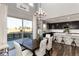 Open-concept dining room view with patio access, kitchen and large central island with barstool seating at 11582 Jimenez St, Parker, CO 80134