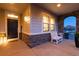 Cozy front porch with stone accents, offering a welcoming space with a white bench and a decorative welcome mat at 11582 Jimenez St, Parker, CO 80134