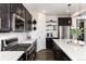 Kitchen featuring stainless appliances, modern white countertops, dark cabinetry, and subway tile backsplash at 11582 Jimenez St, Parker, CO 80134