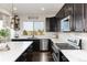 Bright kitchen featuring white countertops, stainless-steel appliances, and a view of the backyard at 11582 Jimenez St, Parker, CO 80134