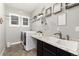 Functional laundry room with a sink, ample counter space, and overhead shelving at 11582 Jimenez St, Parker, CO 80134