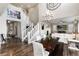 Spacious living room adjacent to the dining room with white staircase and decor at 11582 Jimenez St, Parker, CO 80134
