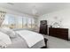 Well-lit main bedroom features a dark wood dresser and lots of natural light from the bright windows at 11582 Jimenez St, Parker, CO 80134