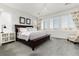 Spacious main bedroom with elegant chandelier, plantation shutters, and sophisticated furnishings at 11582 Jimenez St, Parker, CO 80134