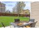 Backyard showing patio dining set with tree, lawn, and privacy fence in the background at 20534 E Union Cir, Aurora, CO 80015