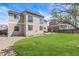 Two-story home exterior features a well-manicured lawn, patio, and outdoor dining set with a grill at 20534 E Union Cir, Aurora, CO 80015