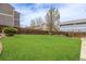 Large backyard featuring lush green grass and a tall wooden fence for privacy at 20534 E Union Cir, Aurora, CO 80015