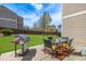 Backyard patio with table, chairs, grill and view of the green lawn and privacy fence at 20534 E Union Cir, Aurora, CO 80015
