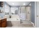 A neutral-toned bathroom features a soaking tub, and a separate shower with glass doors at 20534 E Union Cir, Aurora, CO 80015