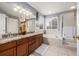 A neutral-toned bathroom features double sinks, a soaking tub, and a separate shower at 20534 E Union Cir, Aurora, CO 80015