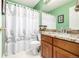 This bathroom features a vanity with a granite countertop, a toilet, and a shower with a decorative curtain at 20534 E Union Cir, Aurora, CO 80015