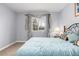 Bedroom featuring light gray walls, neutral carpet, and a window with ornamental curtains at 20534 E Union Cir, Aurora, CO 80015