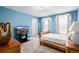 Bedroom featuring blue walls, neutral carpet, and natural light from the windows at 20534 E Union Cir, Aurora, CO 80015