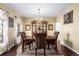 Elegant dining room featuring hardwood floors, a chandelier, and a classic china cabinet at 20534 E Union Cir, Aurora, CO 80015