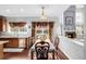 Charming dining room adjacent to the kitchen, showcasing a table setting and a fireplace at 20534 E Union Cir, Aurora, CO 80015