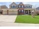 Charming two-story home with a three-car garage and a lush green lawn at 20534 E Union Cir, Aurora, CO 80015