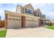 Spacious three-car garage with ample parking and brick accents, great curb appeal at 20534 E Union Cir, Aurora, CO 80015