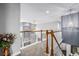 Hallway with railing overlooking a living room with a fireplace and large windows at 20534 E Union Cir, Aurora, CO 80015