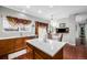 Modern kitchen with a large island, wood cabinets, stainless steel appliances, and an eat-in area at 20534 E Union Cir, Aurora, CO 80015