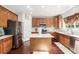 Bright kitchen features stainless steel appliances, an island, wood cabinets and white countertops at 20534 E Union Cir, Aurora, CO 80015