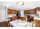 An open concept kitchen and breakfast nook with stainless appliances, an island, and wood cabinets at 20534 E Union Cir, Aurora, CO 80015
