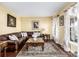 Cozy living room with plush seating, elegant drapes, and hardwood flooring, perfect for relaxation at 20534 E Union Cir, Aurora, CO 80015