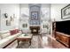 Cozy living room featuring a fireplace with large windows and hardwood floors at 20534 E Union Cir, Aurora, CO 80015