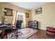 Bright home office features hardwood floors, a desk, bookshelves, and a large window with natural light at 20534 E Union Cir, Aurora, CO 80015
