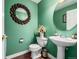 Stylish powder room featuring decorative mirrors and a pedestal sink at 20534 E Union Cir, Aurora, CO 80015