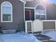 Front entrance of townhome with snowy ground at 5866 W Asbury Pl, Lakewood, CO 80227