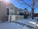 Exterior view of townhome with snowy landscaping at 5866 W Asbury Pl, Lakewood, CO 80227