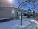 Side view of townhome with snowy landscape at 5866 W Asbury Pl, Lakewood, CO 80227