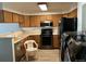 Eat-in kitchen featuring a full range of appliances and oak cabinets at 5866 W Asbury Pl, Lakewood, CO 80227