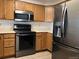 Well-equipped kitchen featuring stainless steel appliances and ample cabinet space at 5866 W Asbury Pl, Lakewood, CO 80227