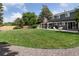 Large backyard with a well-maintained lawn, patio, and mature trees at 6279 E Princeton Ave, Cherry Hills Village, CO 80111