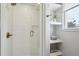 Modern bathroom with a glass-enclosed shower and built-in shelving next to the window at 6279 E Princeton Ave, Cherry Hills Village, CO 80111