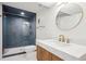 Updated bathroom with glass shower door, brass fixtures, and built-in vanity at 6279 E Princeton Ave, Cherry Hills Village, CO 80111