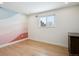 Serene bedroom featuring hardwood floors, neutral tones, and painted accent wall at 6279 E Princeton Ave, Cherry Hills Village, CO 80111
