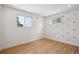 Sunlit bedroom with hardwood floors, white walls, and rainbow decals at 6279 E Princeton Ave, Cherry Hills Village, CO 80111