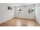 Neutral bedroom with hardwood floors and dual windows offering ample natural light at 6279 E Princeton Ave, Cherry Hills Village, CO 80111