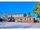 Two-story brick home with a gray upper level, white trim, and a snow-covered front yard at 6279 E Princeton Ave, Cherry Hills Village, CO 80111