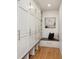 Hallway mudroom with custom built in storage lockers, seat, and hardwood flooring at 6279 E Princeton Ave, Cherry Hills Village, CO 80111