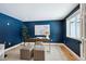 Stylish home office with blue walls, modern desk, and lots of natural light at 6279 E Princeton Ave, Cherry Hills Village, CO 80111