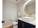 Elegant powder room with stylish wallpaper, gold accents, and a modern vessel sink at 6279 E Princeton Ave, Cherry Hills Village, CO 80111