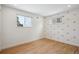 Bright bedroom with hardwood floors and rainbow wall accents at 6279 E Princeton Ave, Cherry Hills Village, CO 80111