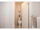 Cozy half bathroom featuring tiled floors, a modern toilet, and tasteful decor at 6001 S Yosemite St # B206, Greenwood Village, CO 80111
