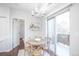 Bright dining area with modern light fixture and sliding door to the balcony at 6001 S Yosemite St # B206, Greenwood Village, CO 80111
